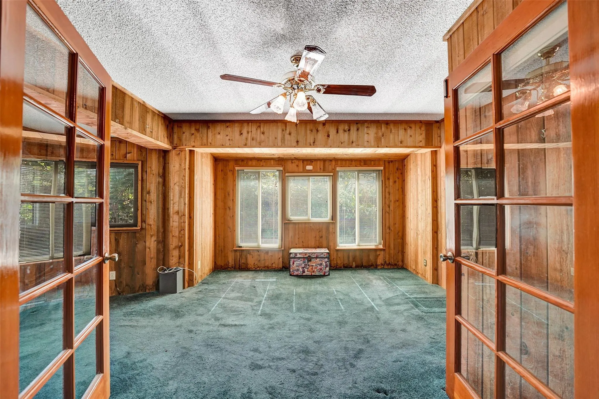 Second bedroom with double French door entry and bay window.