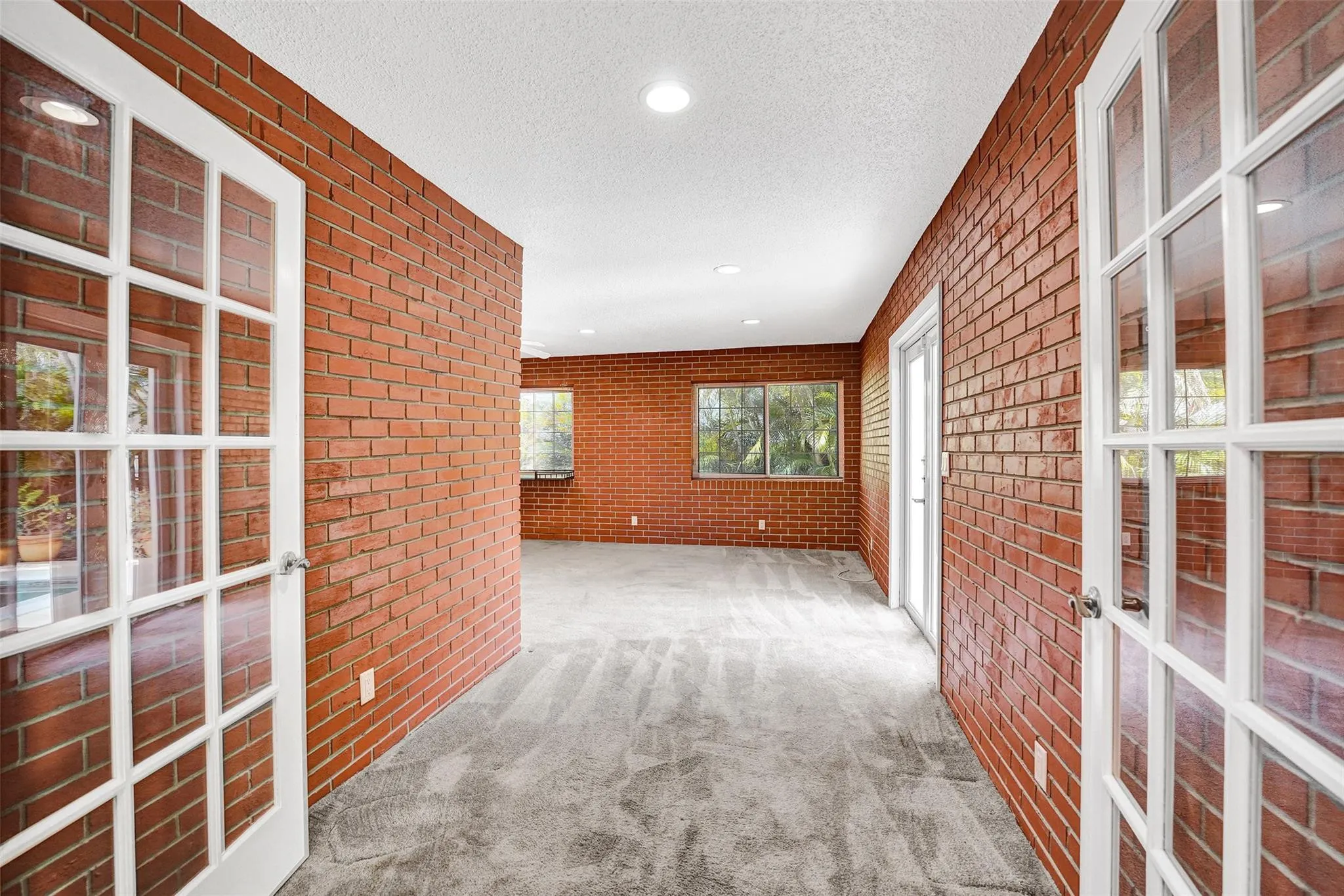 Double French door entry to third bedroom/bath or in-law/guest suite with private exterior access.