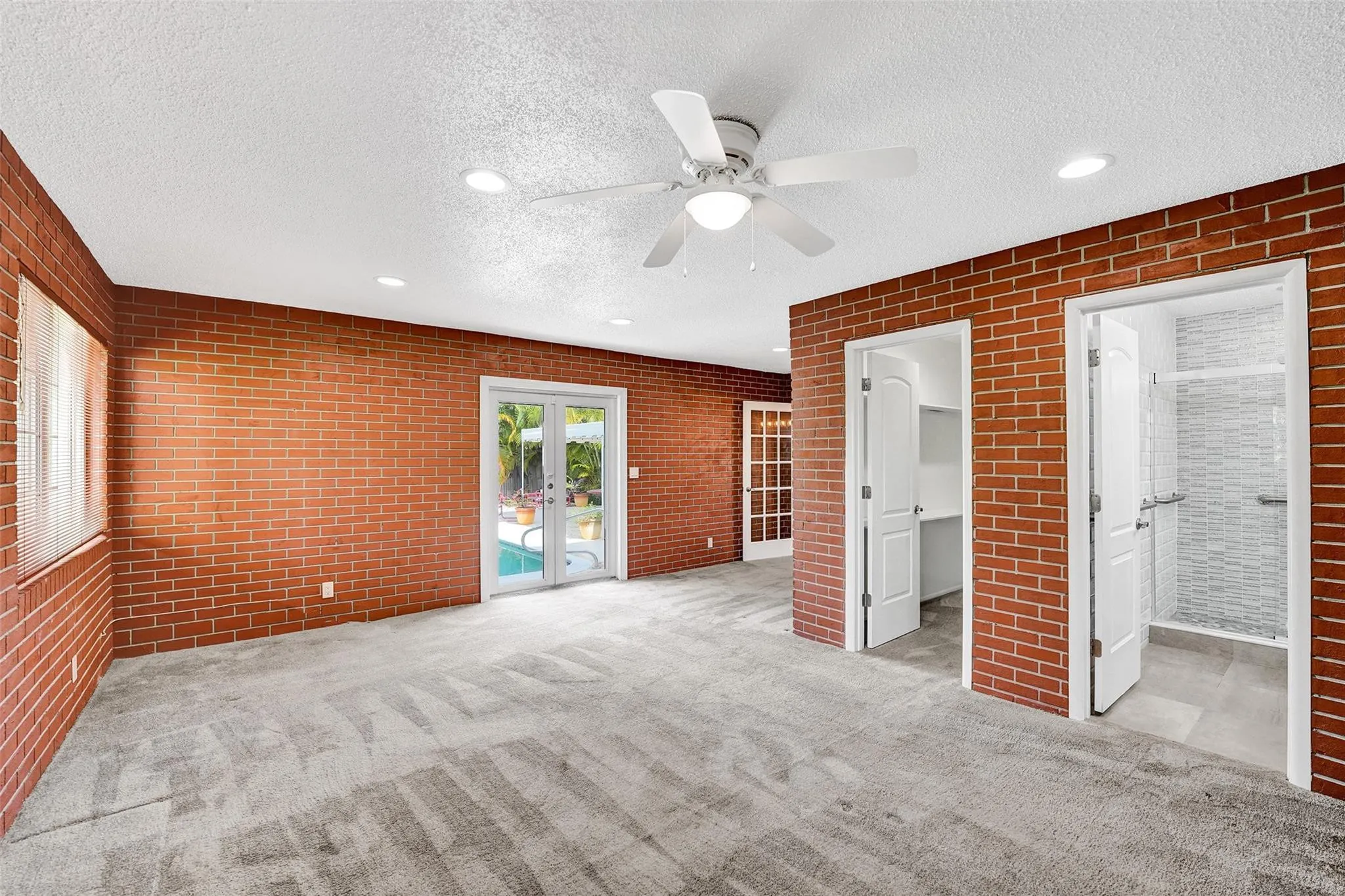 Huge third bedroom/in-law suite with double doors to pool area.