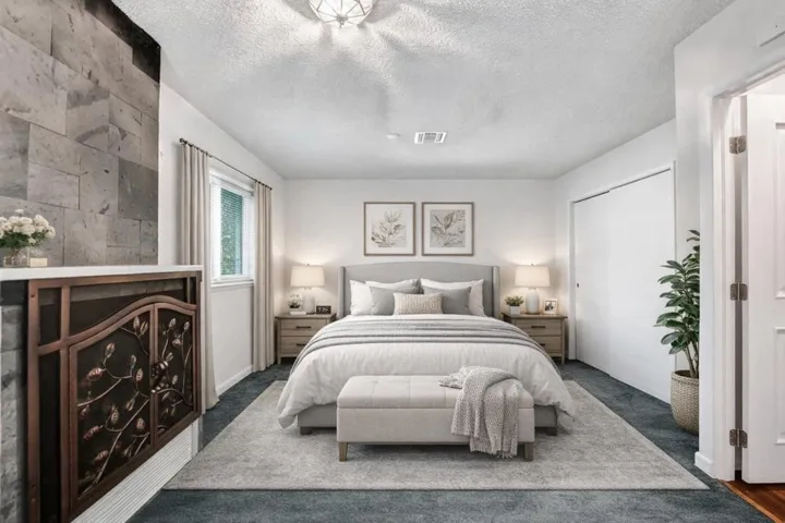 Primary bedroom with large sitting area. Virtually staged.