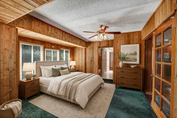 Bedroom virtually staged. Features include French doors and bay window.