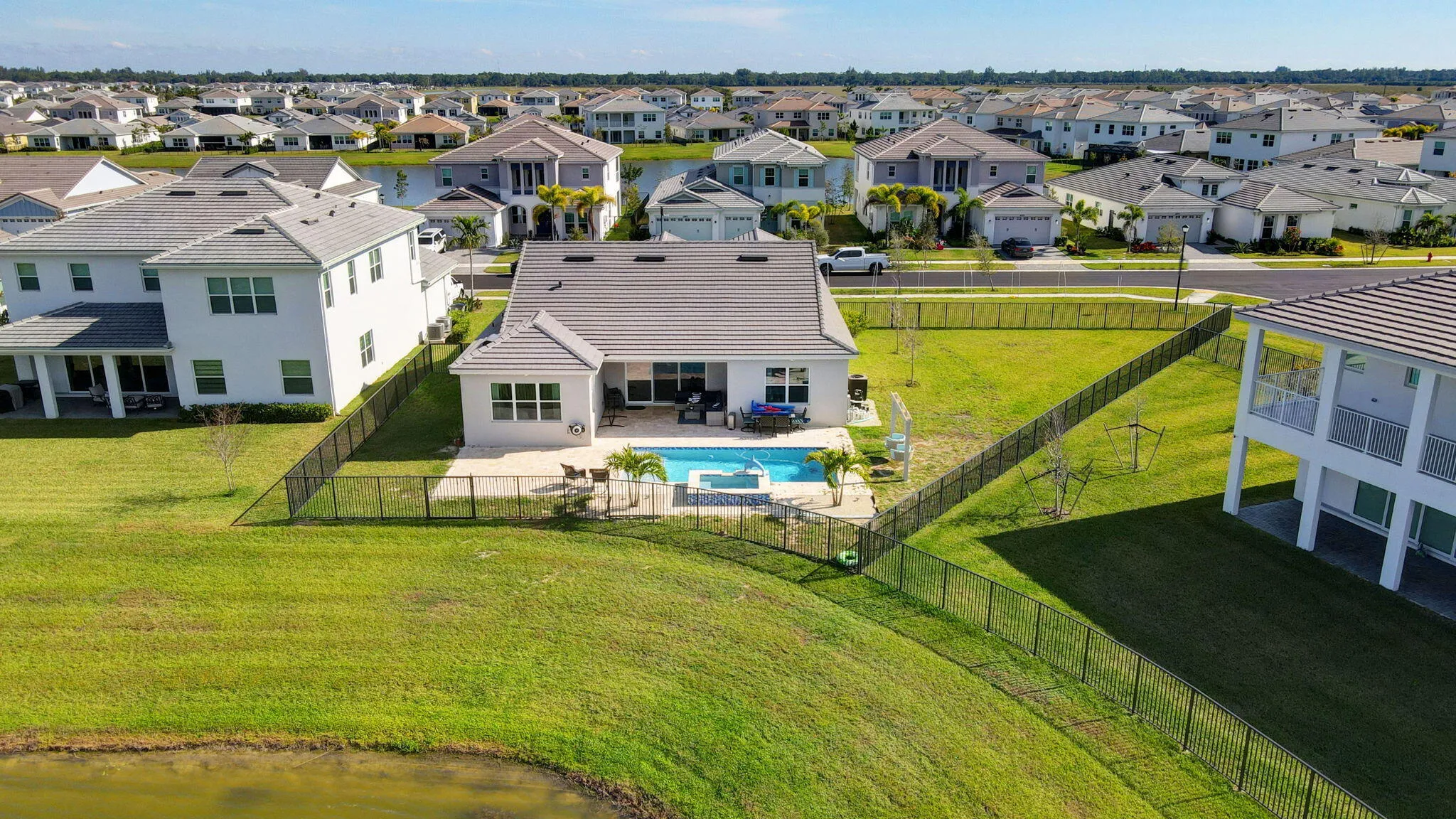 Exterior featuring a private swimming pool, fenced yard, and a tile roof