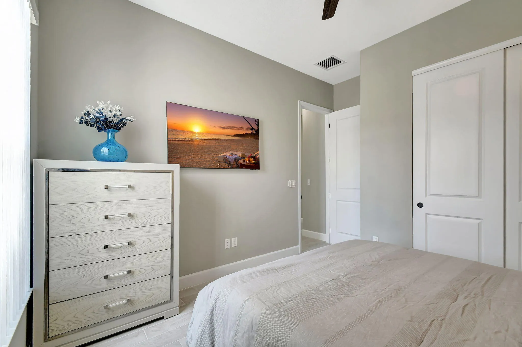 Light gray wall paint, white trim, recessed lighting, and a ceiling fan