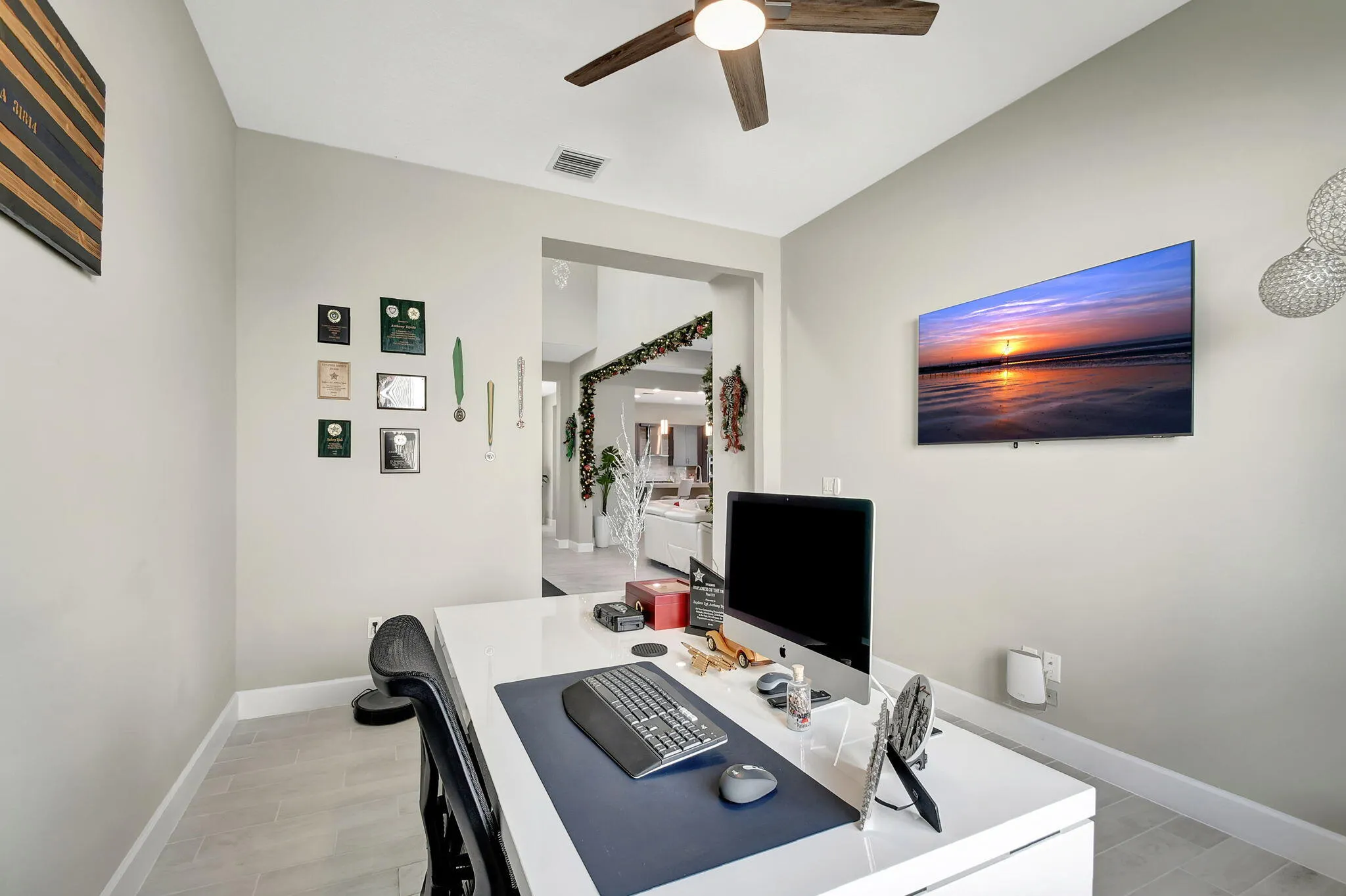 Recessed lighting with a ceiling fan, light gray wall paint, and wood-finish flooring
