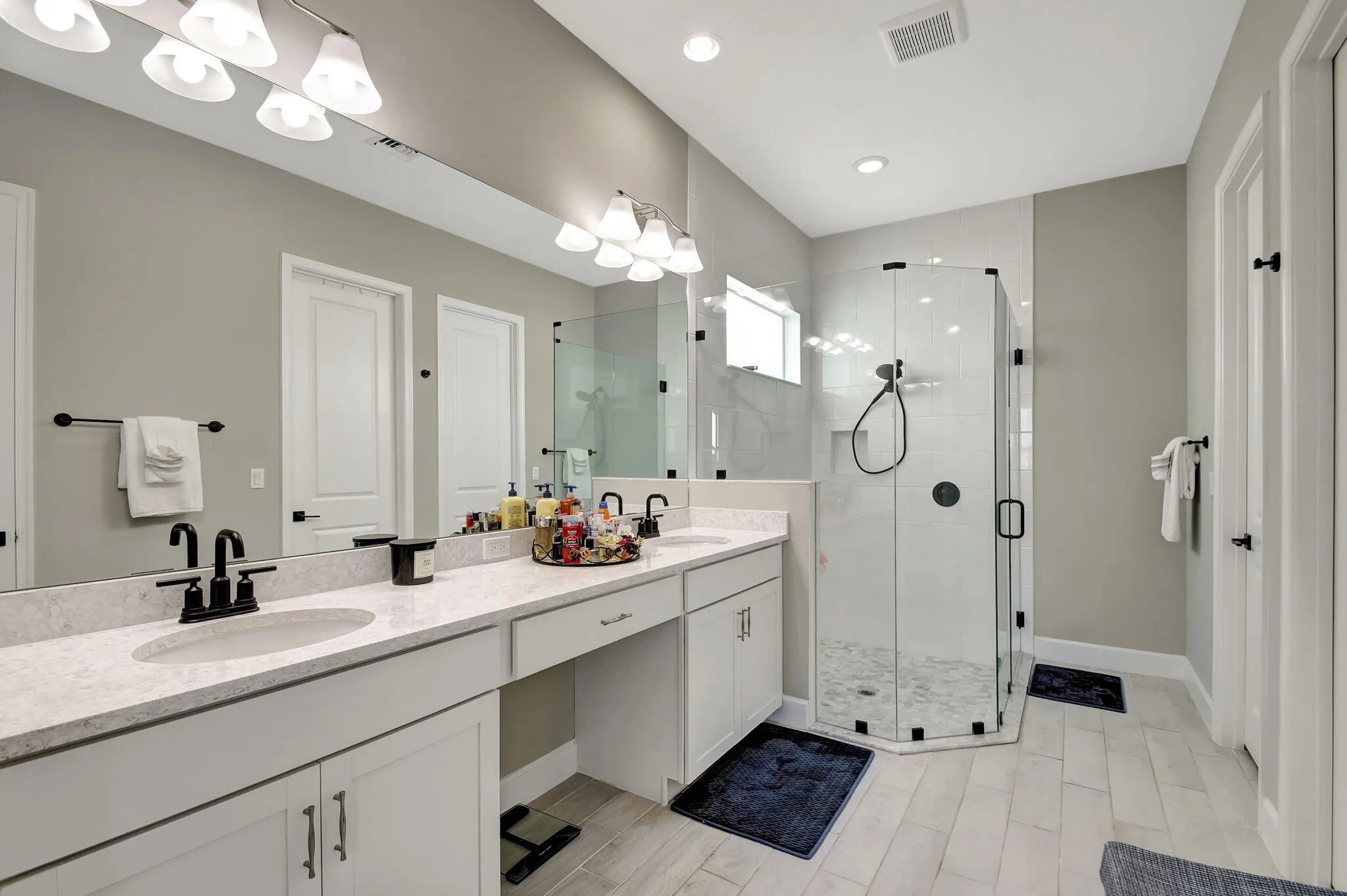 Dual vanity with light-colored countertops and undermount sinks