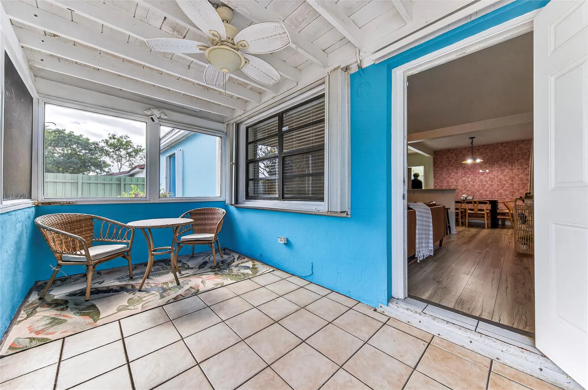Screened in porch and view of open front door
