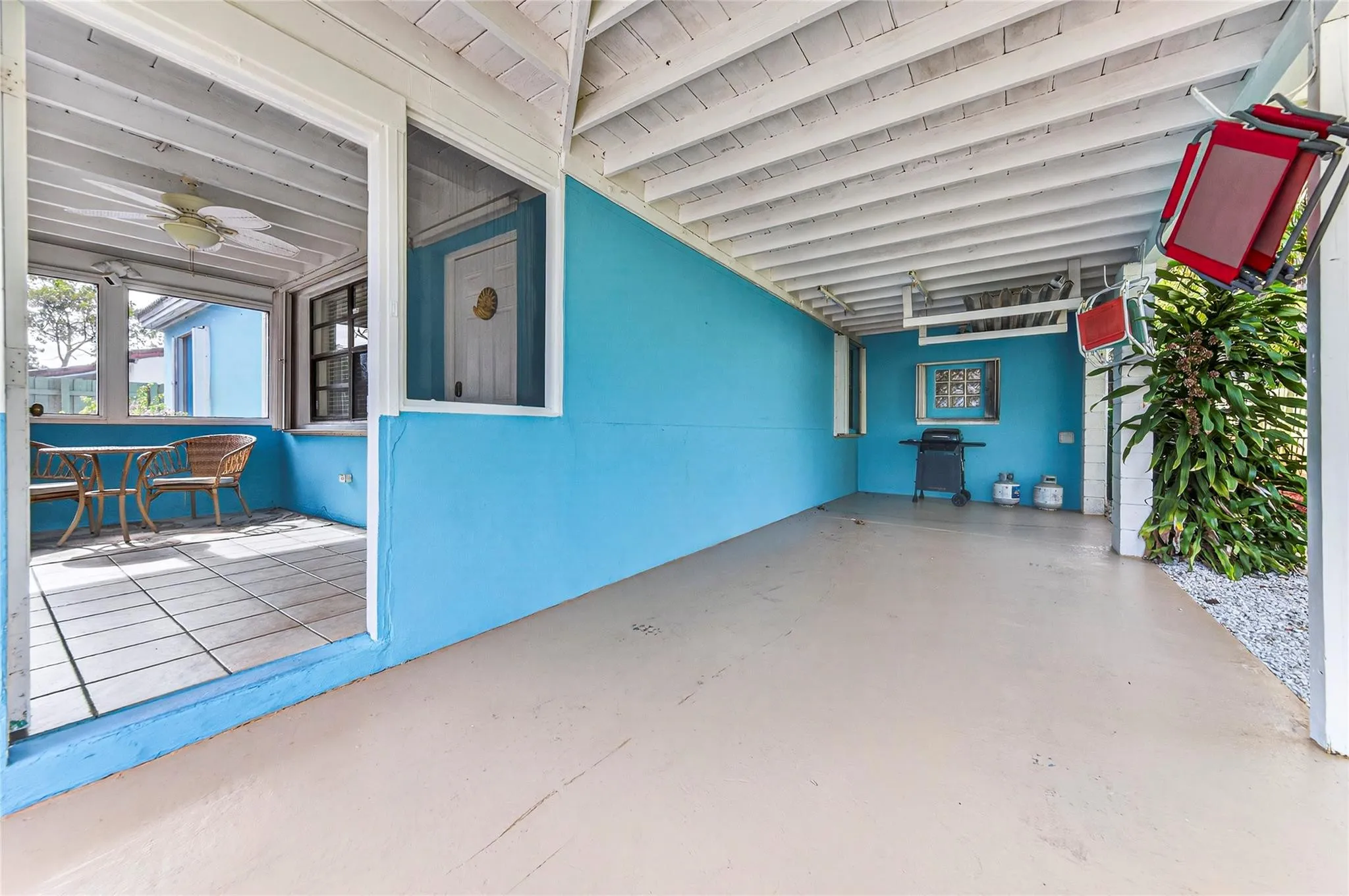 Spacious carport with view into screened porch