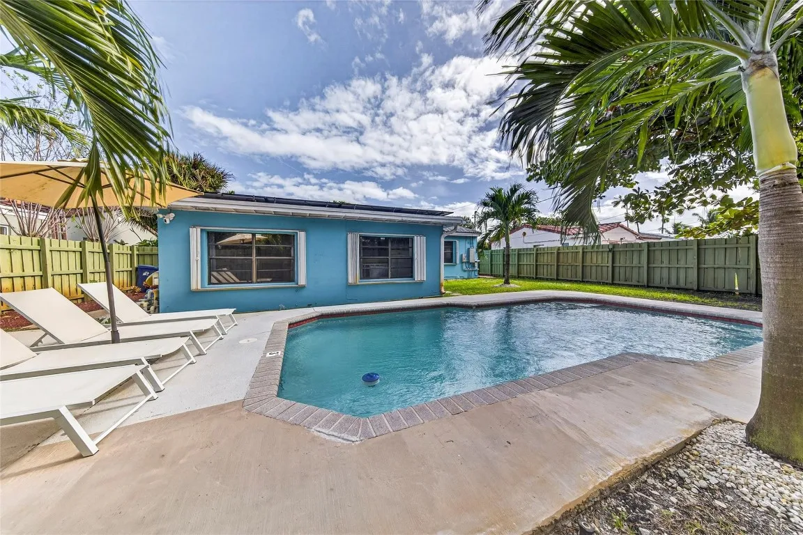 Back yard with deck, pool and vegetation