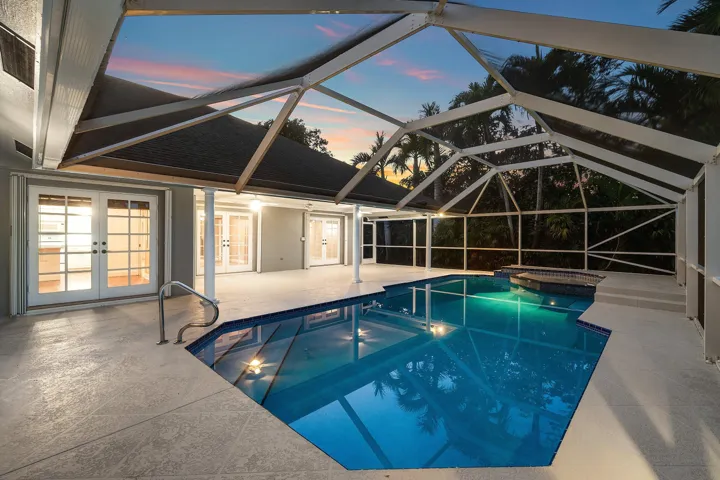 View from patio/pool area into breakfast nook, kitchen, dining room, and primary bedroom