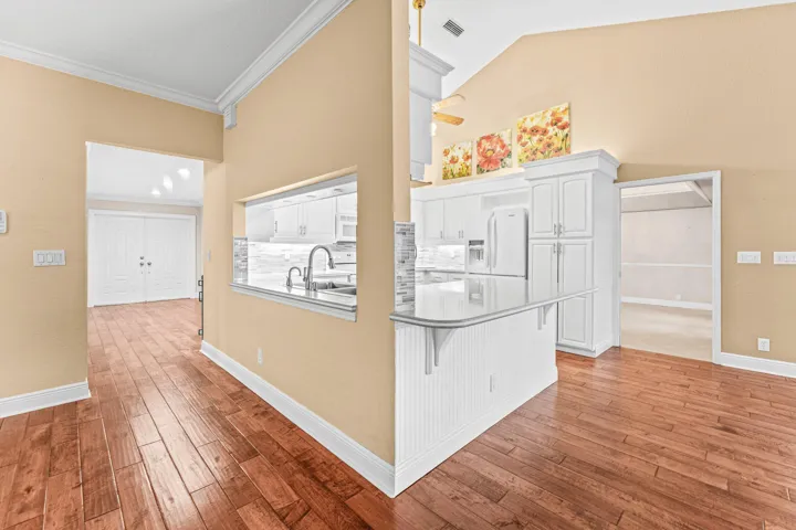 View of front door, kitchen and formal dining room