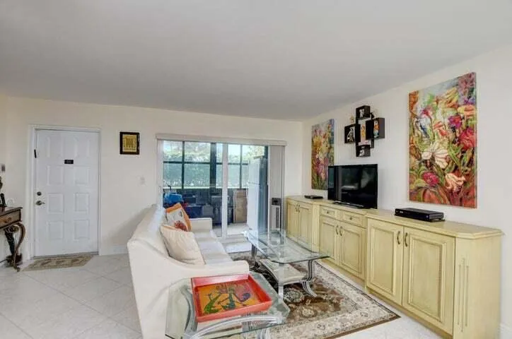 LOOKING AT ENCLOSED LANAI AND FRONT DOOR