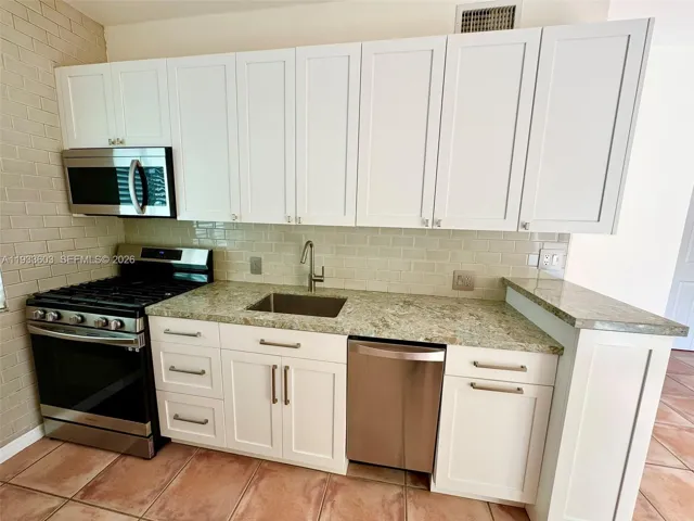 New Stone Countertop and Cabinets and Stainless Steel Appliances