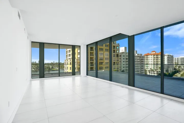 The kitchen and living room enjoy views and plenty of light through the floor to ceiling windows.