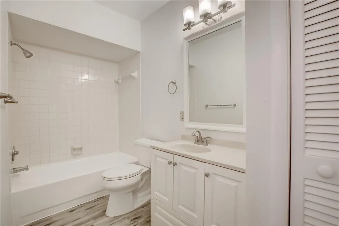 Bathroom which features an updated vanity and linen closet.