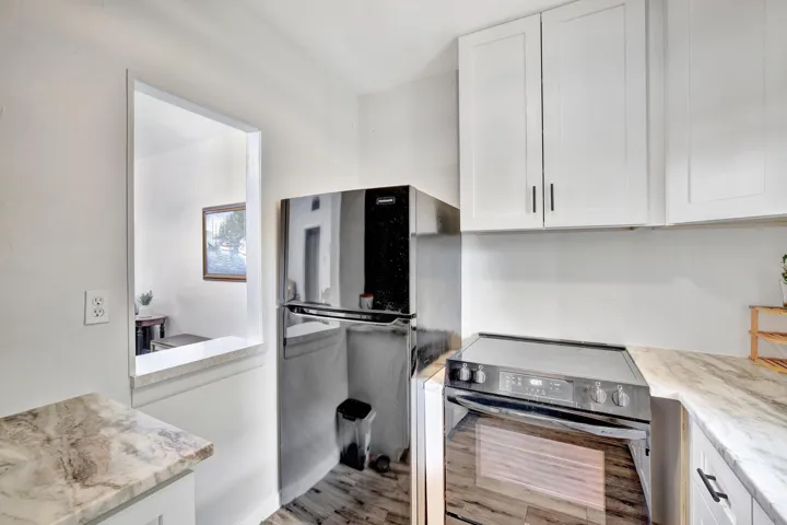 Kitchen with window overlooking dining/living area