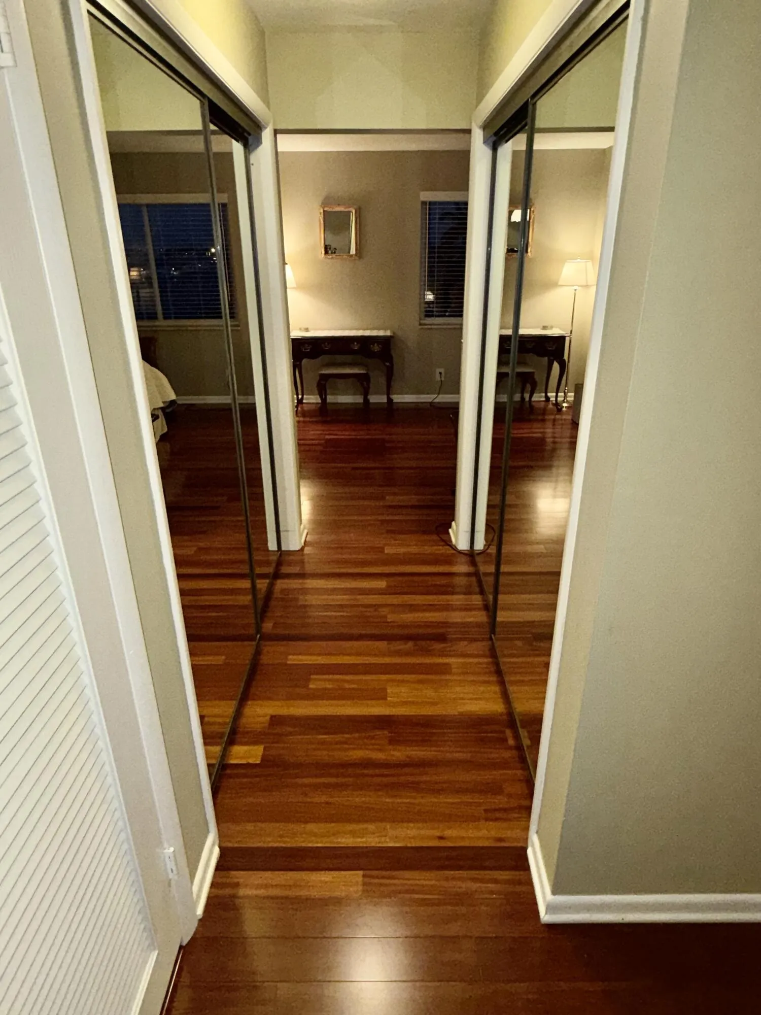 Hall from bath into secondary bed room, with mirrored closets.