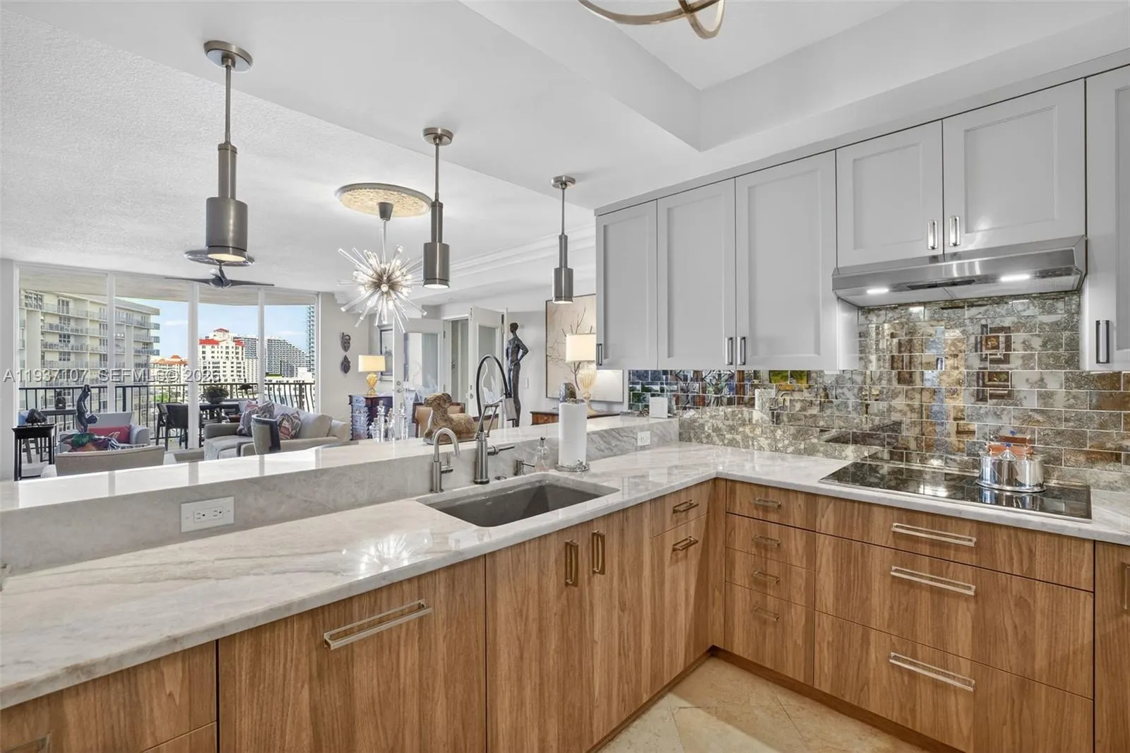 Spectacular kitchen w/ custom bleached walnut veneer cabinetry by renowned Chicago based millworker. Grain matches from top to bottom. Taj mahal quartzite. Wolf induction cooktop & double oven (w/ microwave / convenction at top oven), Sub Zero Refrigerator & Beverage Cooler, Miele Dishwasher. Sink w/ touchless Brizo faucet, including water filtration faucet. Antiqued mirror backsplash