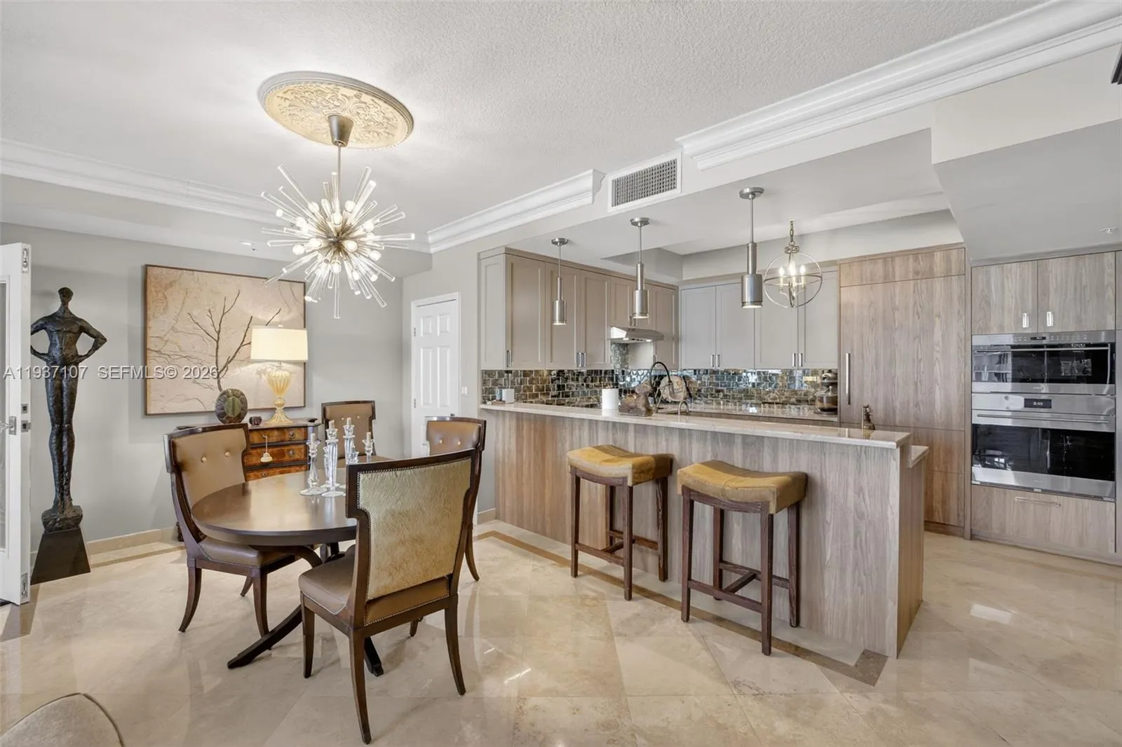 Spectacular kitchen w/ custom bleached walnut veneer cabinetry by renowned Chicago based millworker. Grain matches from top to bottom. Wolf induction cooktop & double oven (w/ microwave / convenction at top oven), Sub Zero Refrigerator & Beverage Cooler, Miele Dishwasher. Antiqued mirror backsplash