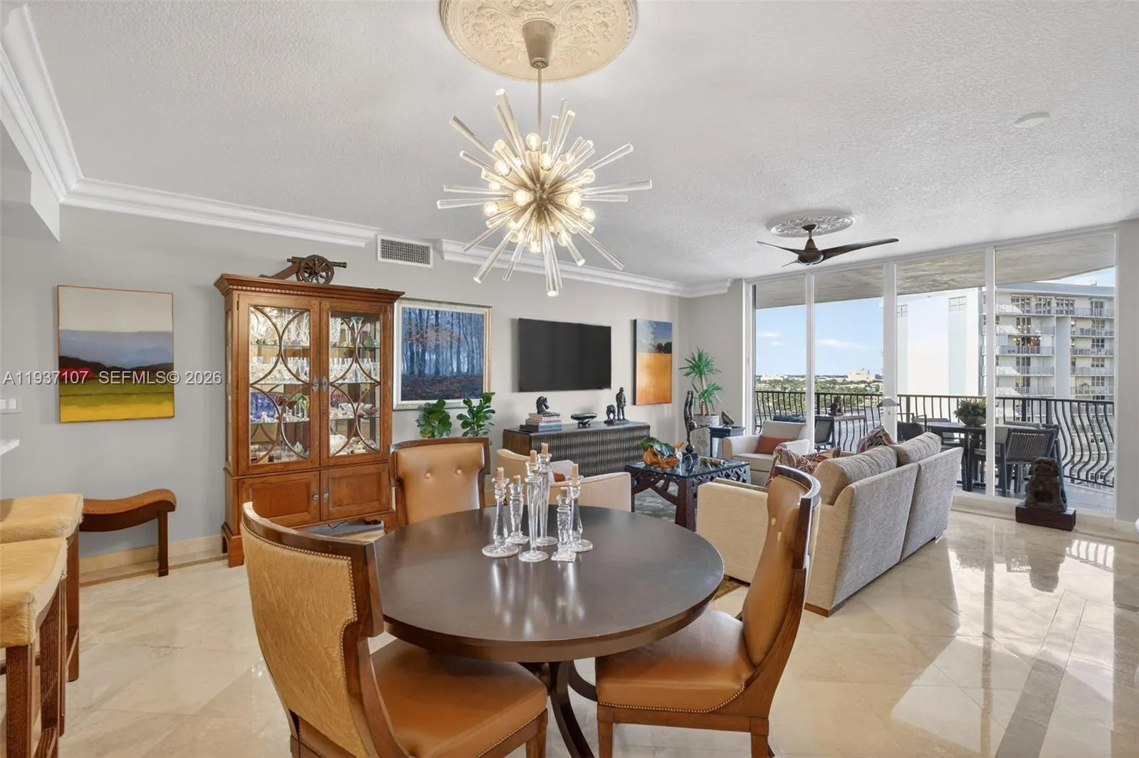 Beautiful sputnik chandelier, Emtek crystal door hardware throughout unit, counter seating at kitchen. Crown molding.