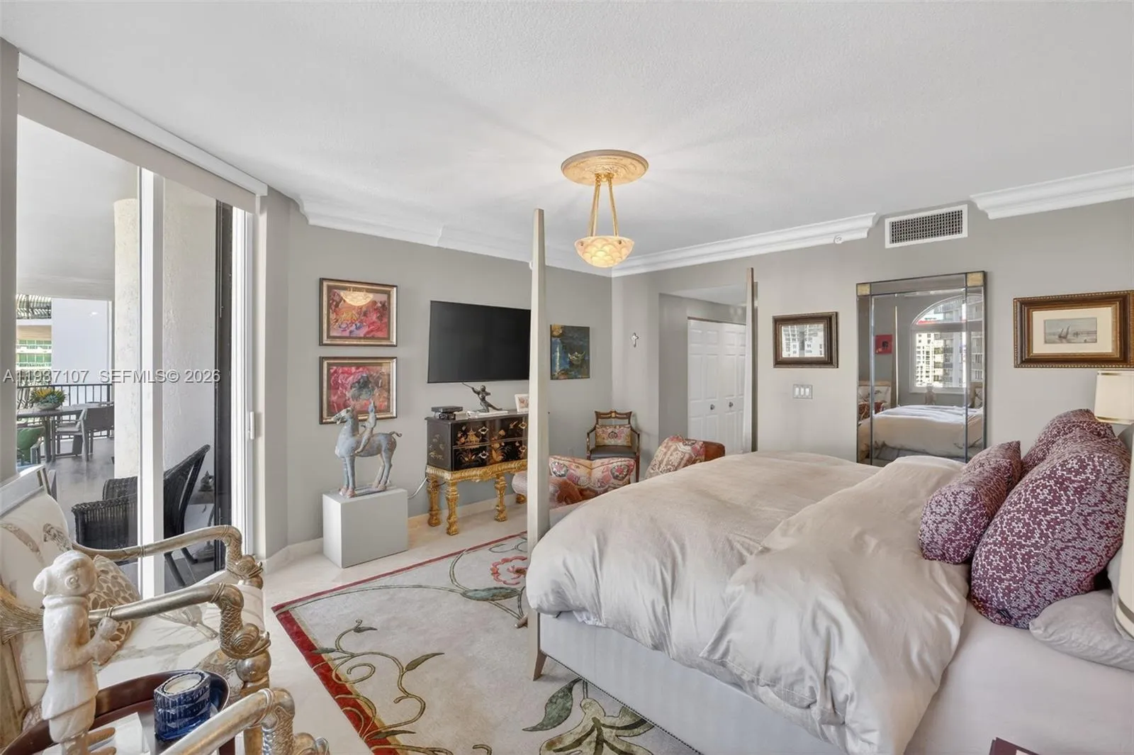 Large primary bedroom w/ motorized room blackout shades and sitting area