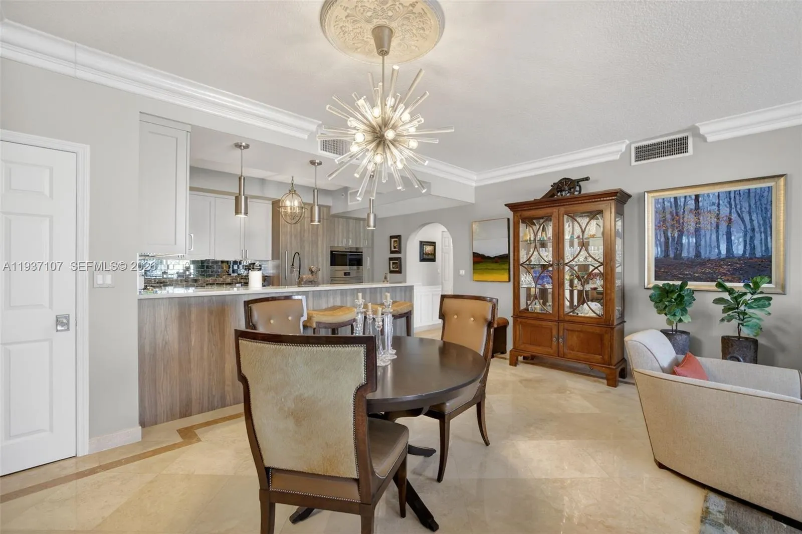 Beautiful sputnik chandelier, Storage closet (w/ Emtek crystal door hardware throughout unit), counter seating at kitchen. Crown molding.