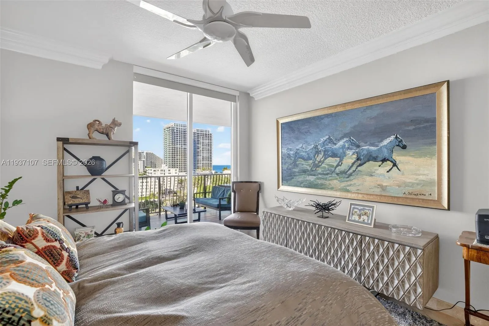 Guest bedroom (2nd primary bedroom) w/ sliders off to the balcony and ocean views & motorized window roller shade.