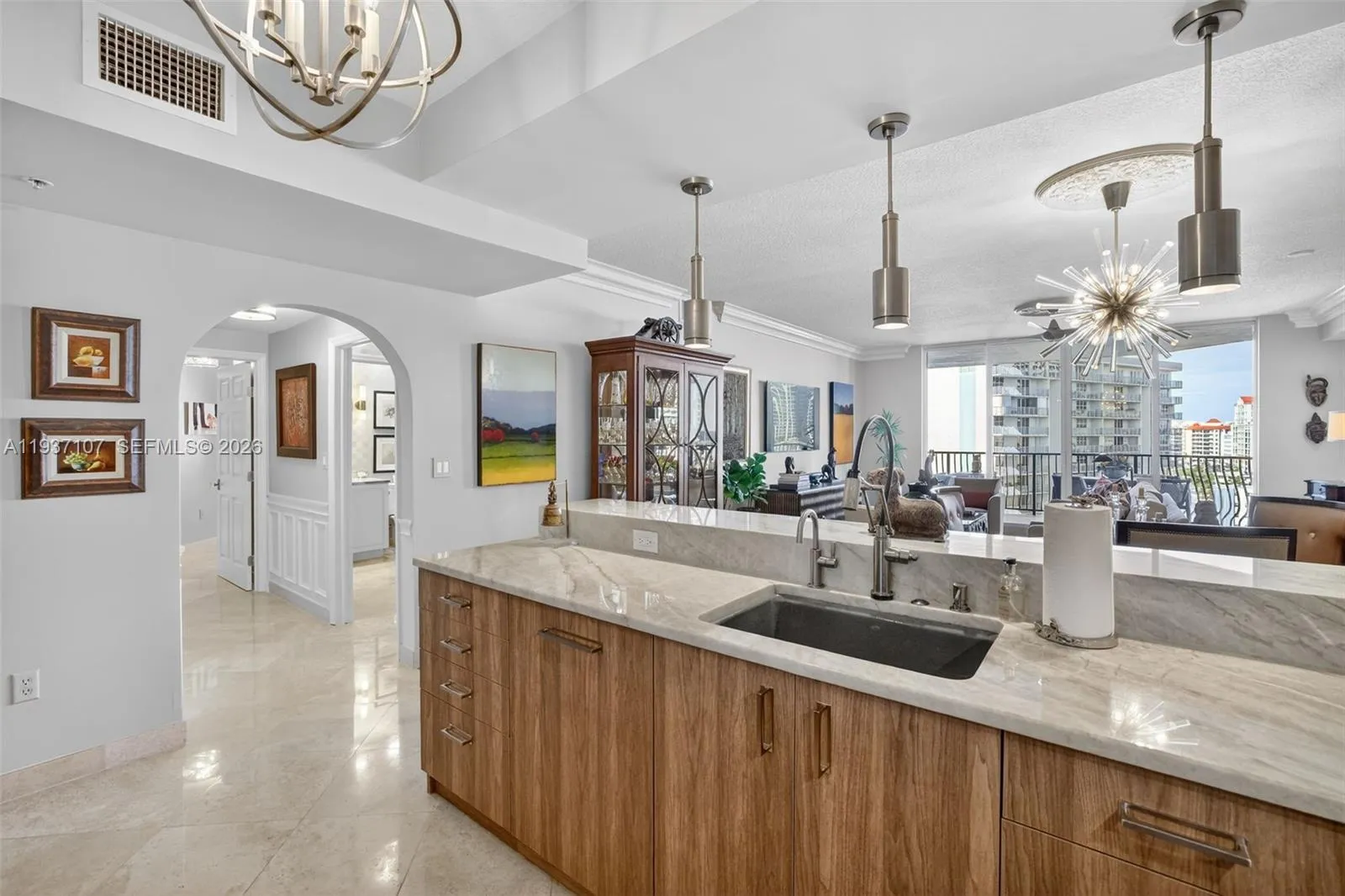 Spectacular kitchen w/ custom bleached walnut veneer cabinetry by renowned Chicago based millworker. Grain matches from top to bottom. Taj mahal quartzite. Wolf induction cooktop & double oven (w/ microwave / convenction at top oven), Sub Zero Refrigerator & Beverage Cooler, Miele Dishwasher. Sink w/ touchless Brizo faucet, including water filtration faucet. Antiqued mirror backsplash