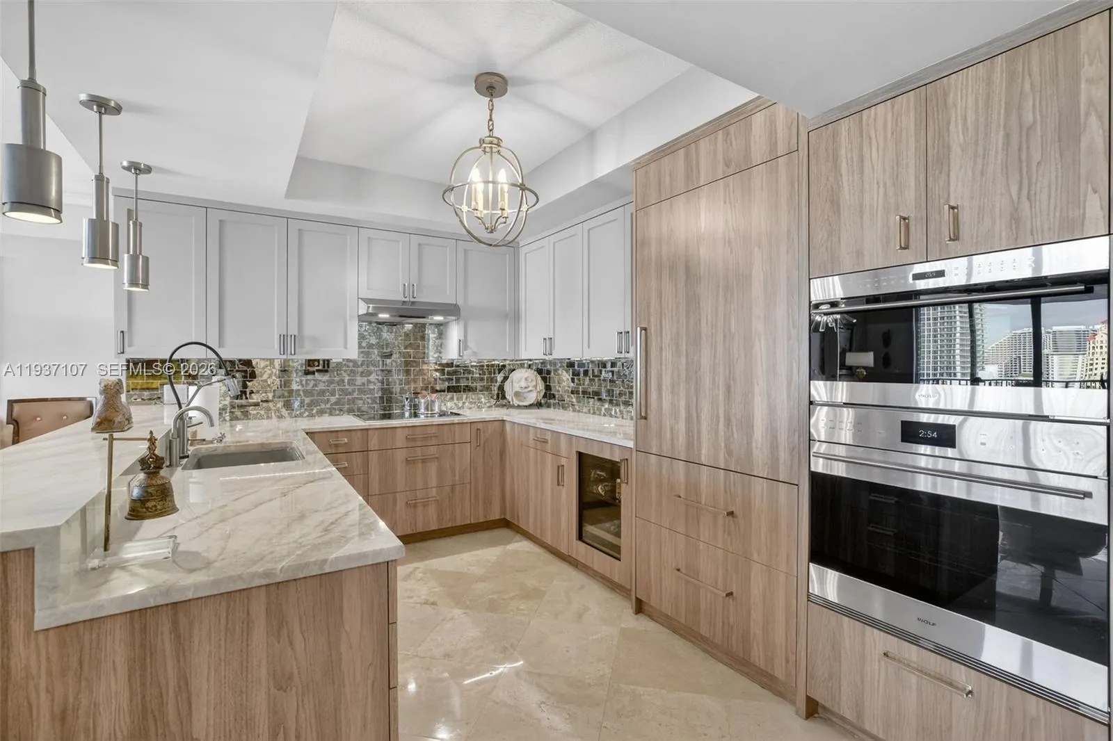 Spectacular kitchen w/ custom bleached walnut veneer cabinetry by renowned Chicago based millworker. Grain matches from top to bottom. Taj mahal quartzite. Wolf induction cooktop & double oven (w/ microwave / convenction at top oven), Sub Zero Refrigerator & Beverage Cooler, Miele Dishwasher. Sink w/ touchless Brizo faucet, including water filtration faucet. Antiqued mirror backsplash