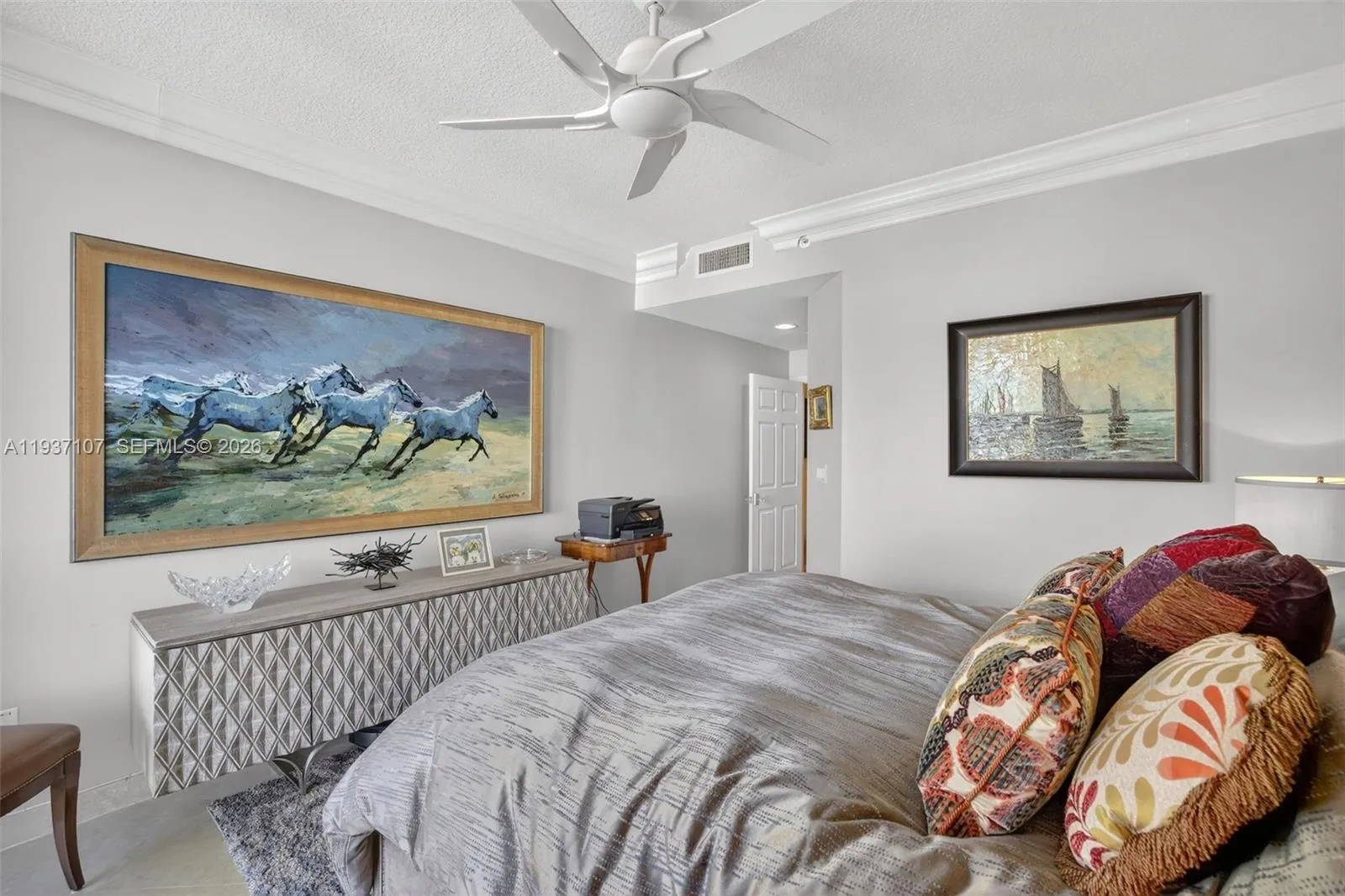 Guest bedroom (2nd primary bedroom) w/ fan w/ remote & crown molding, marble flooring.