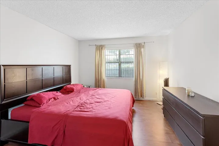 Surprisingly large master bedroom with laminate floors