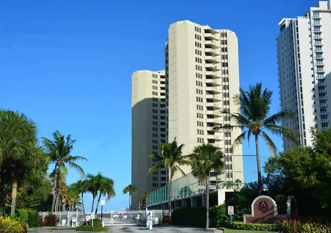 Towering multi-story residential building with multiple private balconies