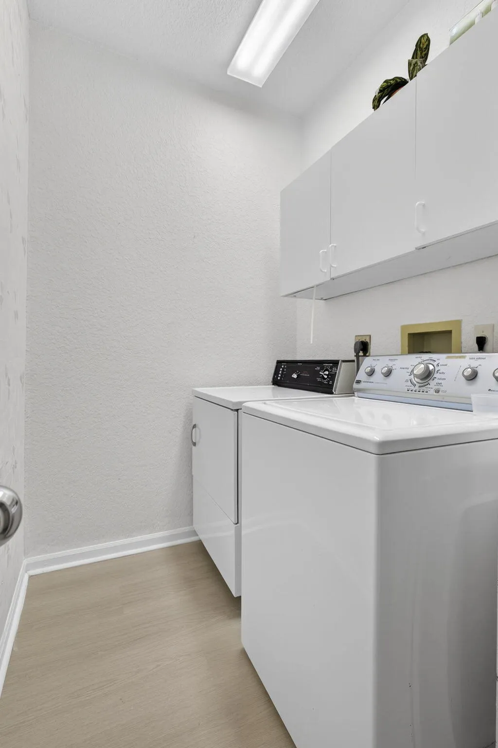 There is a storage closet in the laundry room