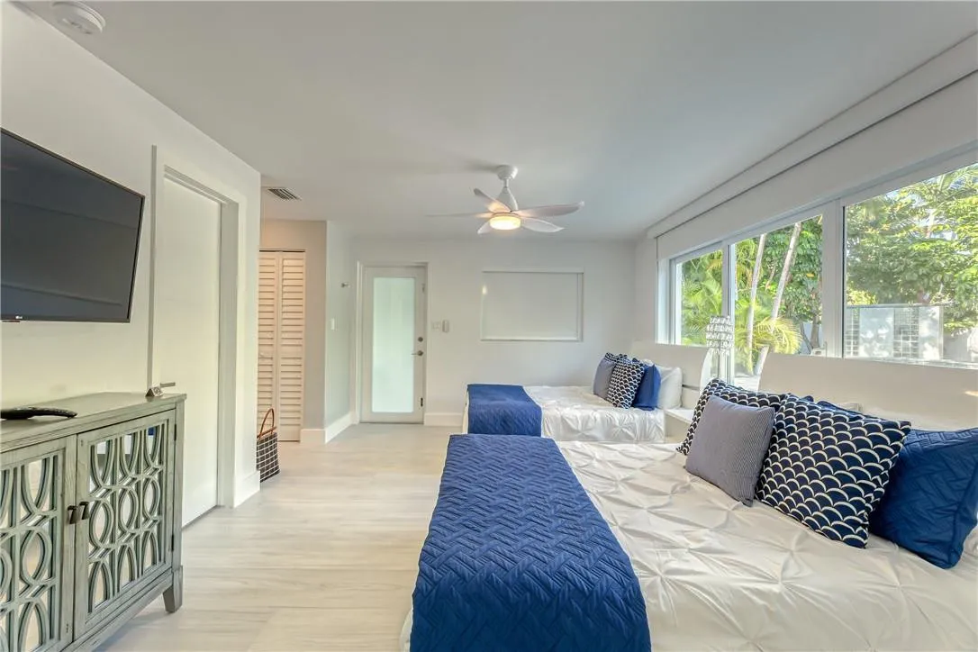 Bedroom #2 with exterior door to escape to the pool...