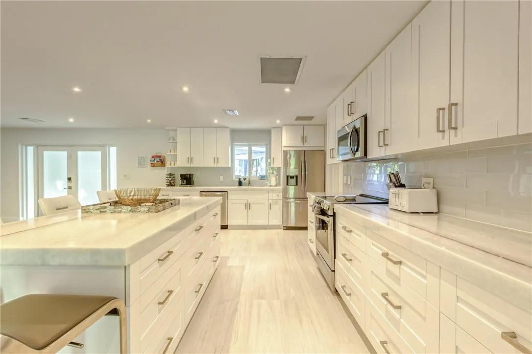 Marble Island bar with 5 barstools and expansive chef's kitchen.