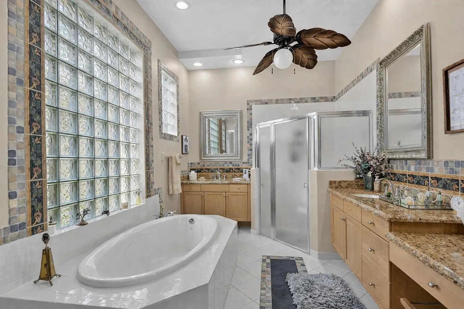 Soaking tub plus step in shower and dual cabinettry, tile accents and a linen closet too!