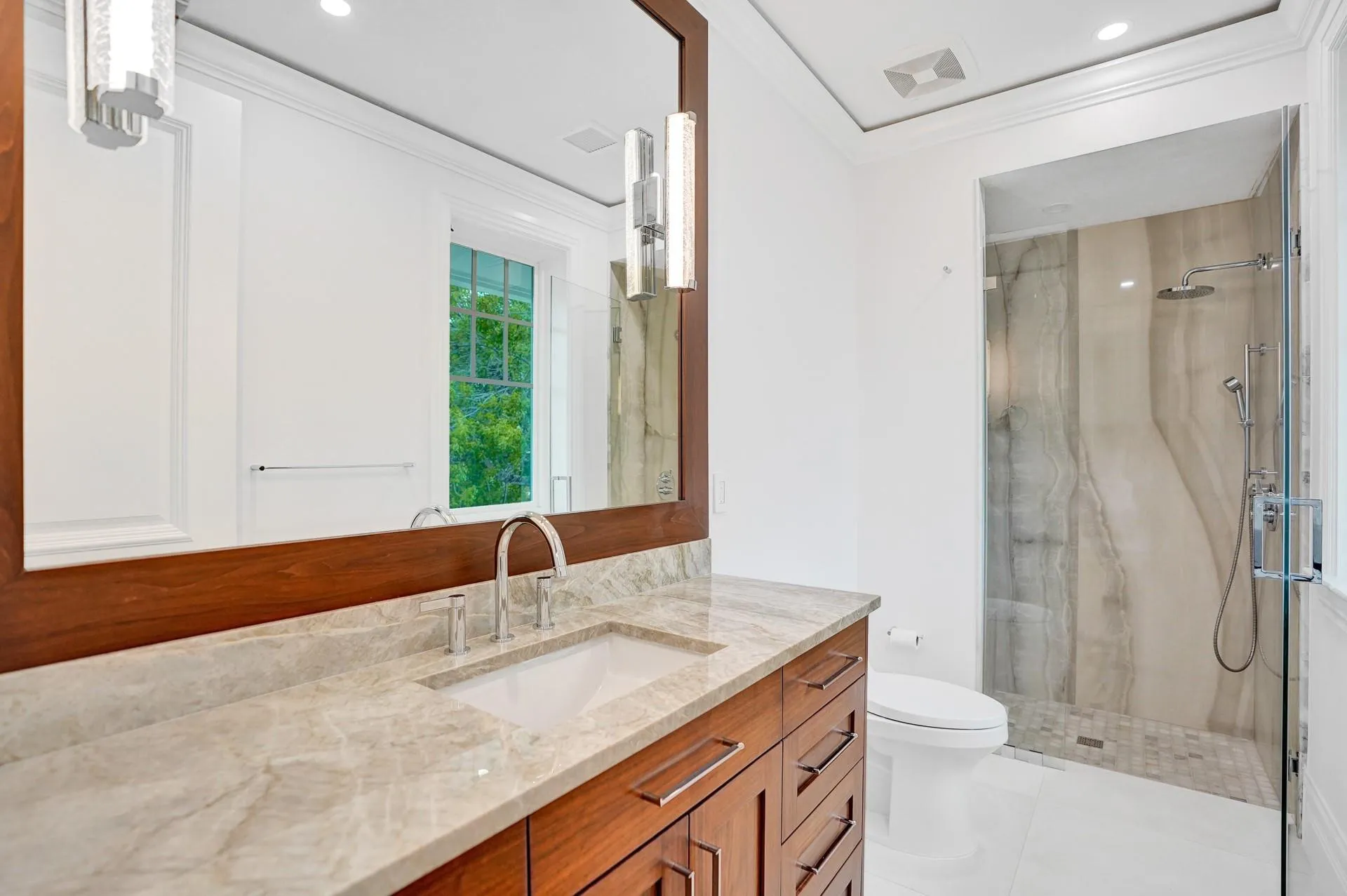 Spacious guest bedroom with walk-in closet and ensuite bathroom.