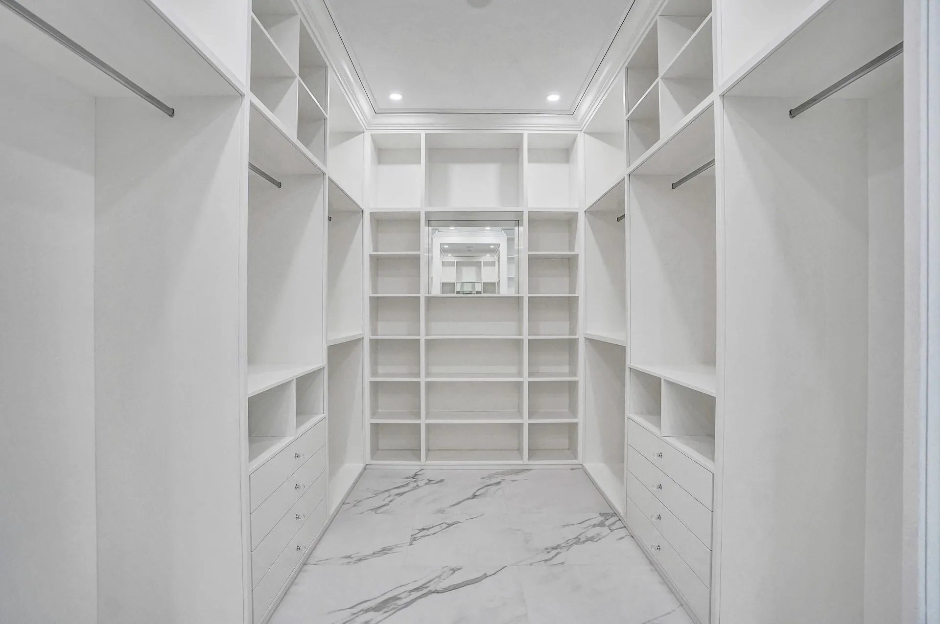 The primary suite boasts separate his-and-hers bathrooms; her bathroom features a spa-like soaking tub, makeup vanity, and a spacious walk-in closet.