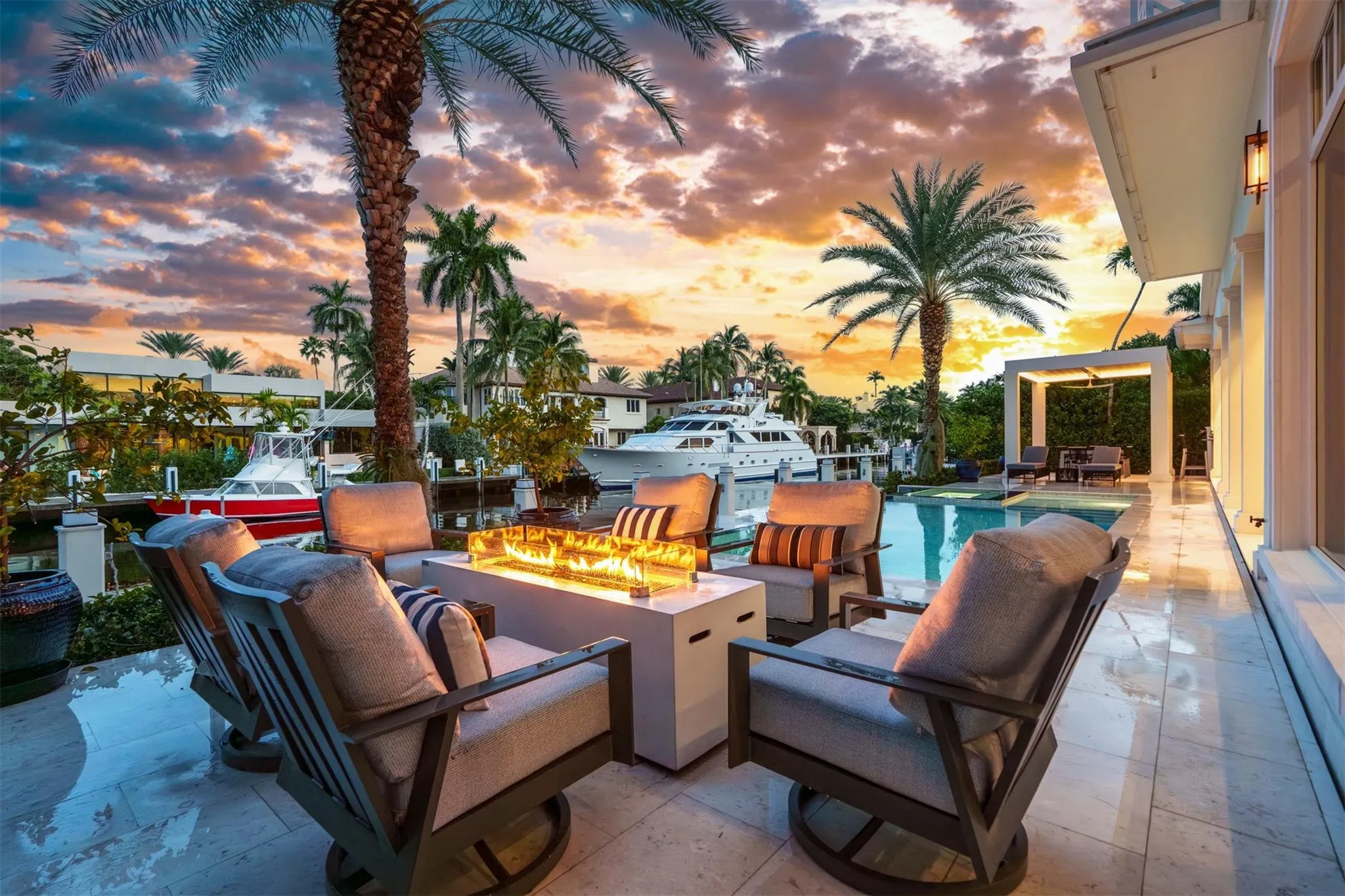 Outdoor gas fire place and seating area creates ambiance and warmth on chilly South Florida nights.
