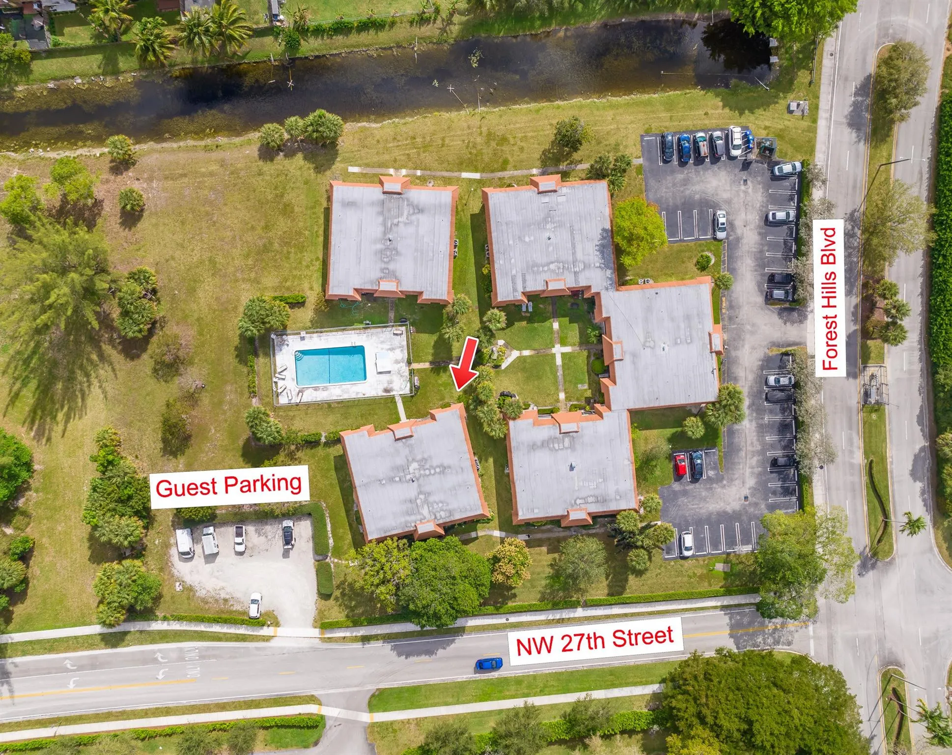 Aerial view showing parking and pool
