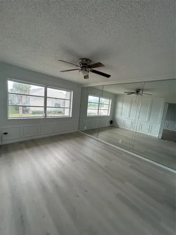 Huge Master Bedroom with wall to wall custom ( wainscoting) wood work, wall to ceiling Mirrors with tons of closet space ( His and Hers) New flooring installed.