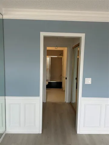 View of Master Bathroom from the Master Bedroom, His and Hers closet on each side of the hallway to the Master Bathroom. 3rd closet at the entrance of the bedroom. Bathroom has tub and shower.