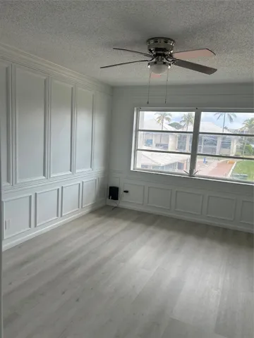 Huge Master Bedroom - custom wood work ( wainscoting), view of the St. Lucie River, club house, pool, etc. 3 different closet spaces! New flooring just installed.