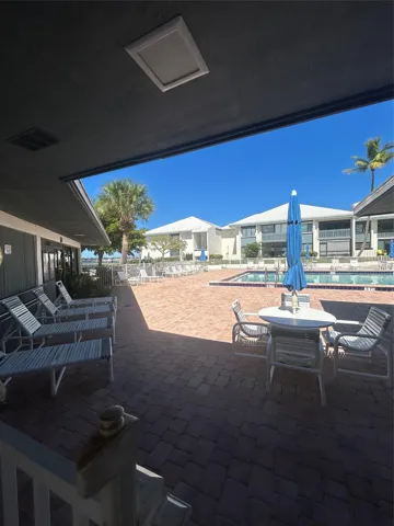 Community pool overlooking the St. Lucie River. Situated to the Club house, pier, gym, library and shuffle board. The condo overlooks this area.