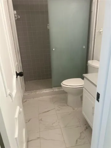 2nd Bathroom/ Guest Bathroom - marble flloor, glass door shower, linen closet to the left of the door. New vanity installed but not shown in this photo.