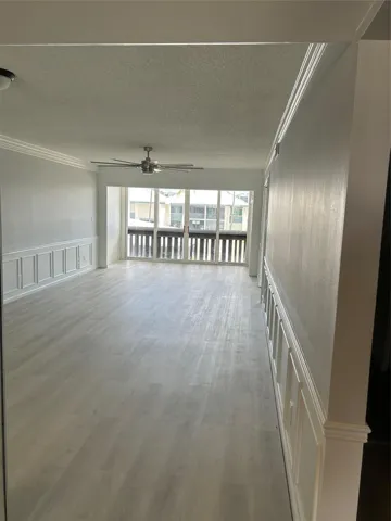 View of the Living/ Family Room/ Balcony and from the entrance of the condo. The 2nd bedroom/ guest bedroom, guest bathroom and storage is to the right of this entry way.