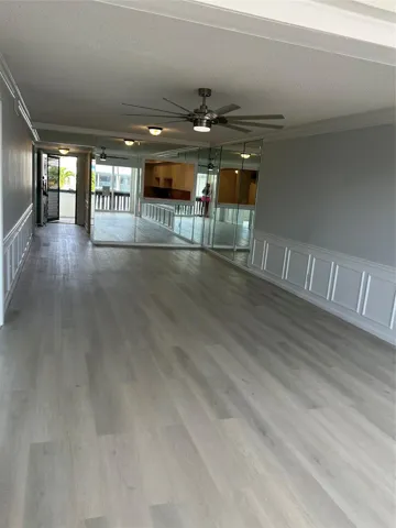 Living / Family space looking towards foyer and kitchen / bar area.