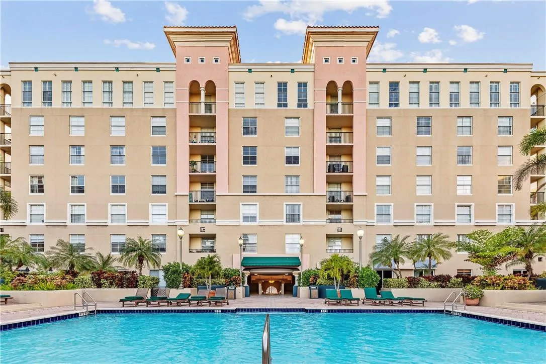 Stunning pool area surrounded by lush landscaping, featuring cabanas, a hot tub, shower, and more for ultimate relaxation.