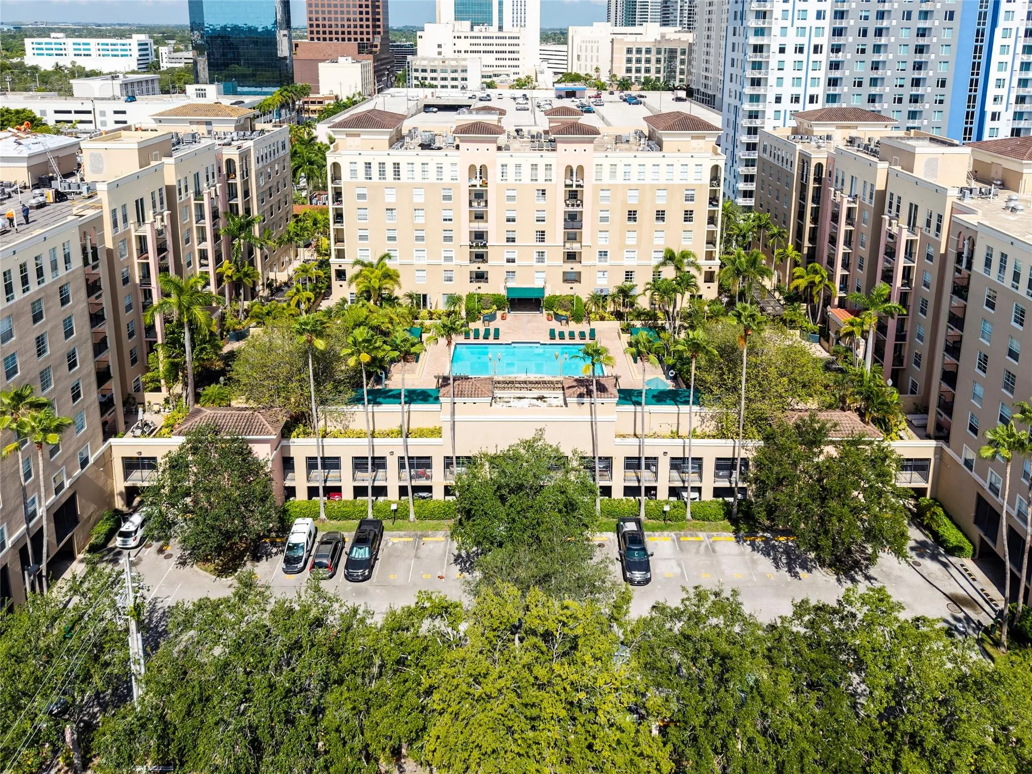 Stunning pool area surrounded by lush landscaping, featuring cabanas, a hot tub, shower, and more for ultimate relaxation.