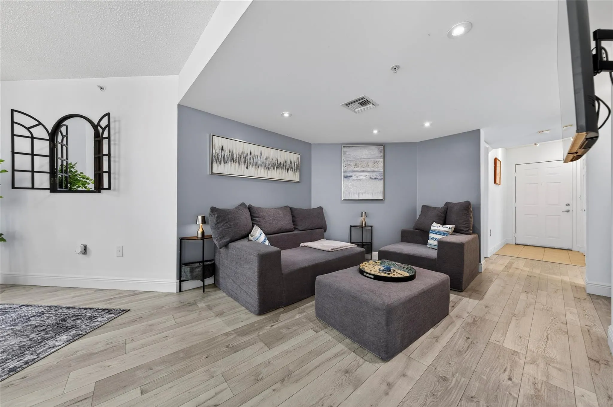 Spacious living room with an open layout, abundant natural light, and seamless flow to the dining area—ideal for relaxing or entertaining.