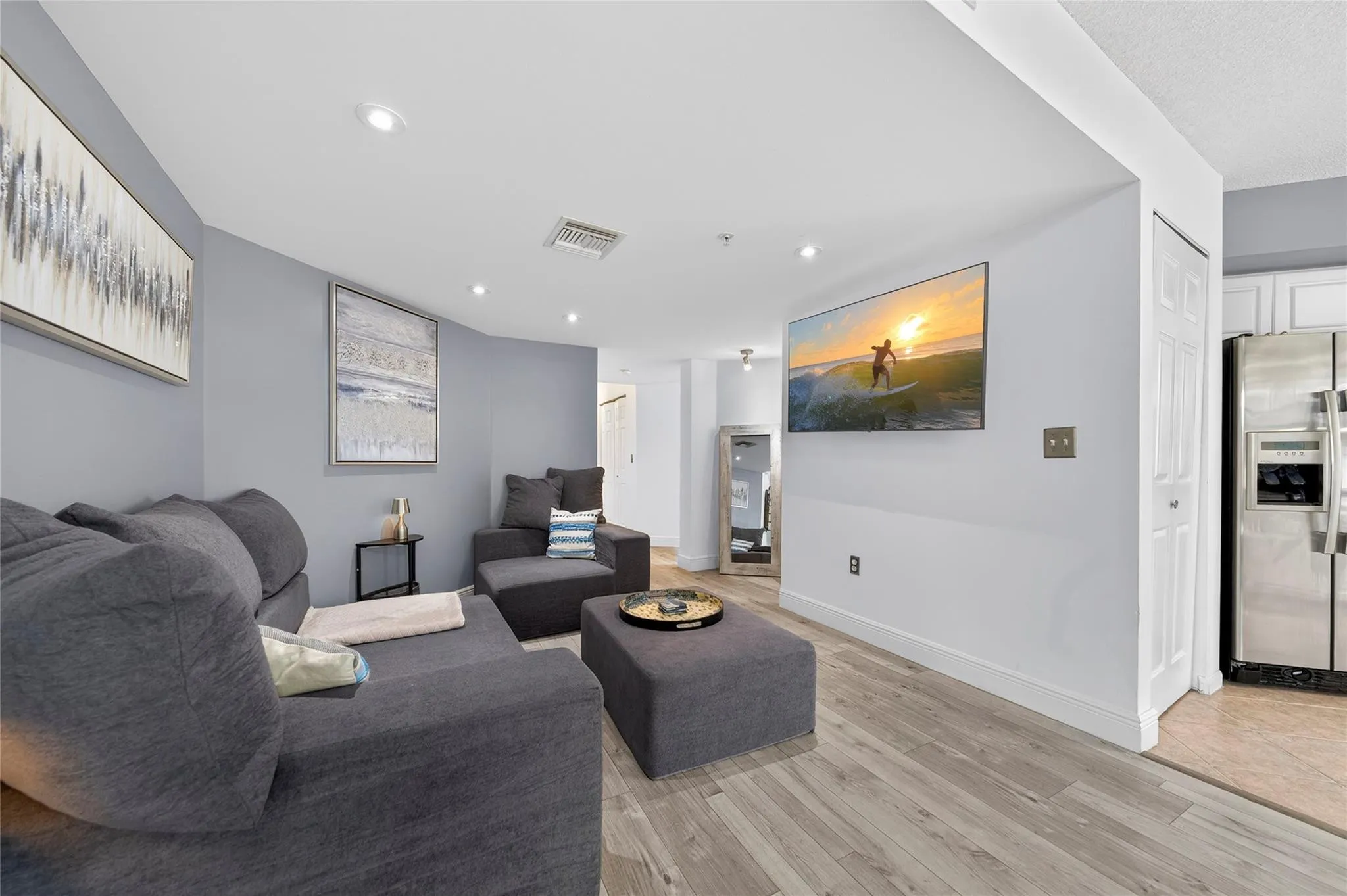 Spacious living room with an open layout, abundant natural light, and seamless flow to the dining area—ideal for relaxing or entertaining.